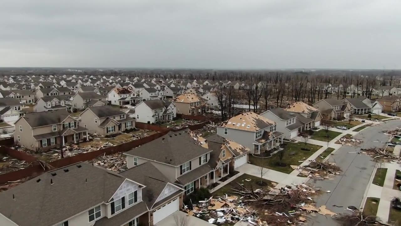 Aerial view of a hail-damaged neighborhood where roofing contractors file insurance supplement claims