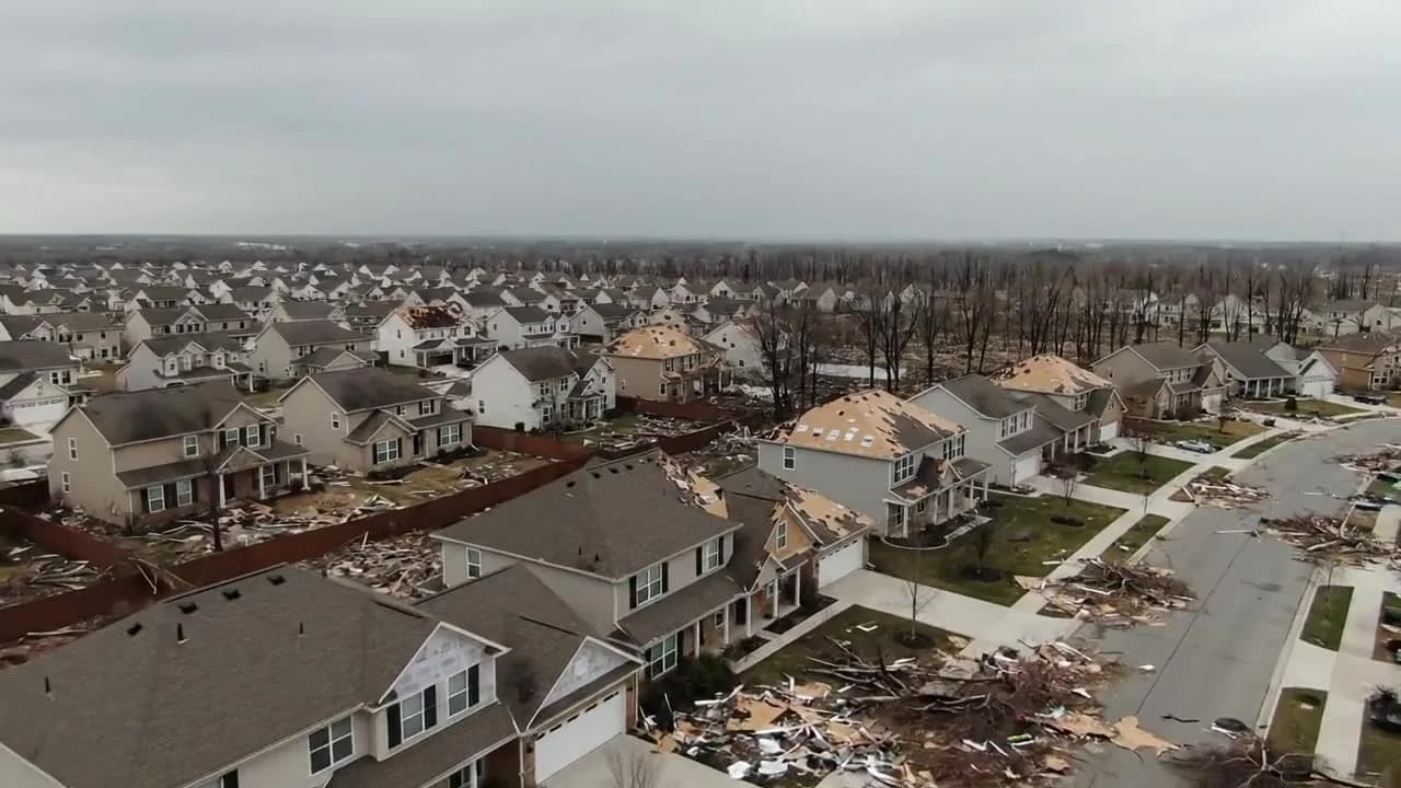 Aerial view of a hail-damaged neighborhood where roofing contractors file insurance supplement claims